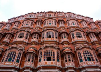 Low angle view of the iconic Hawa Mahal showcasing its elaborate facade in Jaipur, India.